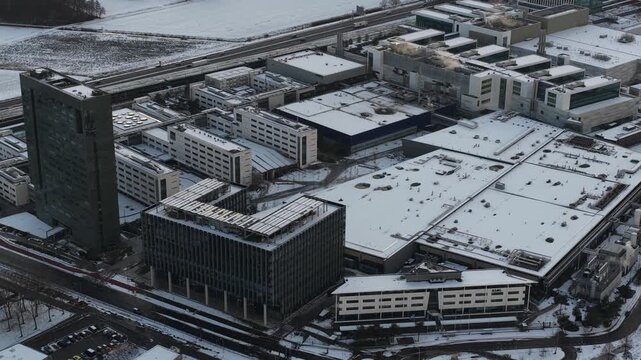 Aerial footage, ASML company grounds, building facades with ASML logos, cleanrooms, production halls, advanced semiconductor manufacturing facilities of the world&rsquo;s leading EUV lithography supplier.