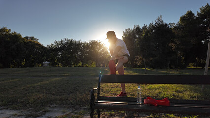 Man stretching after exercising and jogging in a park.