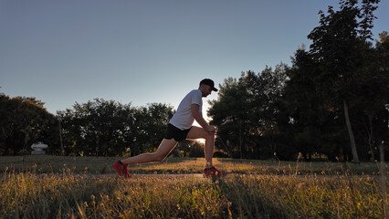 Man stretching after exercising and jogging in a park.