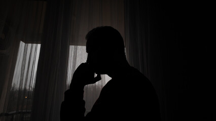 Man with headache, depression, sadness and loneliness at home