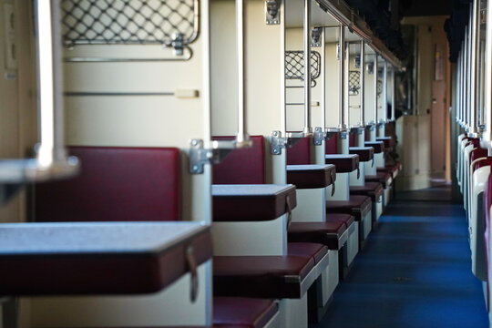 Sitting in a passenger train compartment.