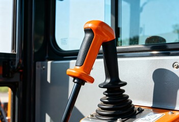 Control joystick in the cabin of an excavator or heavy equipment. Close-up of an industrial machinery operator's lever