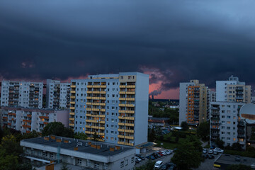 A storm approaching the city. A bird's-eye view of dark storm clouds at sunset. A bright sunset after rain.