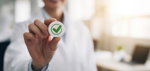 The green check mark token held by a professional in a bright office