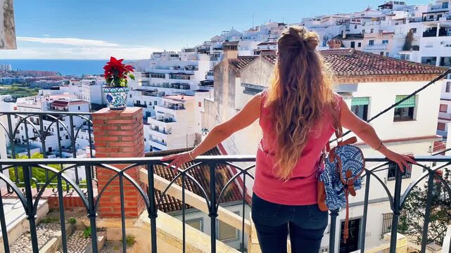 woman tourist enjoying typical view of white city in Andalusia, Travel in Spain