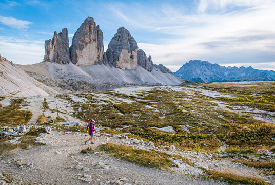 Woman trail running through the dramatic Tre Cime di Lavaredo