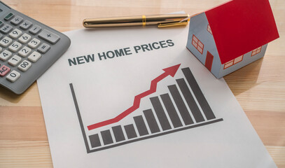 A printout on the table of a graph showing rising new home sales.