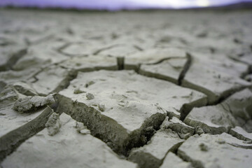 Cracked and dried mud in an empty dam, climate change image