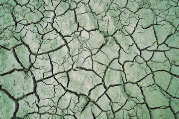 Cracked and dried mud in an empty dam, climate change image