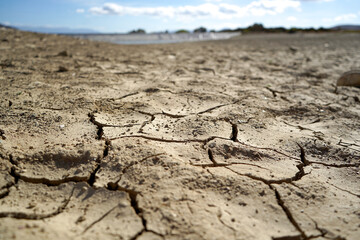 Cracked and dried mud in an empty dam, climate change image