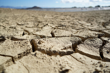 Cracked and dried mud in an empty dam, climate change image