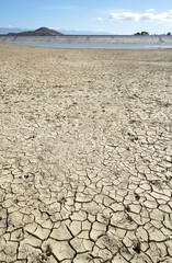 Cracked and dried mud in an empty dam, climate change image