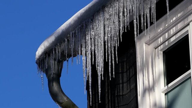 icicles on a house in winter 4k 25fps video