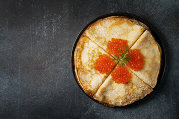 Stack of pancakes with caviar on plate