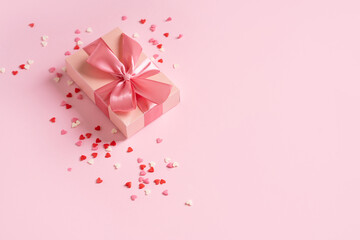 Valentines day concept with pink bow gift box and pink heart shape conffeti