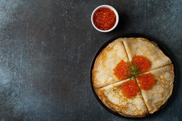 Stack of pancakes with caviar on plate