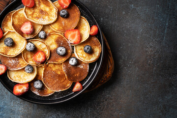 Mini pancakes with blueberries and strawberries