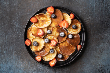 Mini pancakes with blueberries and strawberries