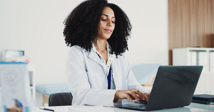 Doctor, woman or typing on laptop in hospital office, digital resources or healthcare database for info. Medical archive, research or physician with pc for telehealth, patient admin or check report