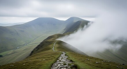 Mountain range with foggy cloudy sky.