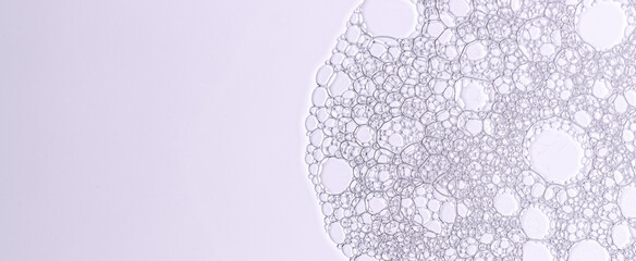 The texture of the foam of shower gel or soap suds or shaving foam. Cosmetic skin care product. Macrophotography. Copy space