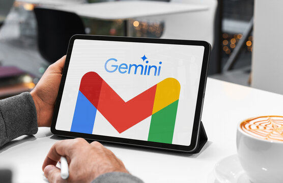 Person using tablet with gemini and gmail logos