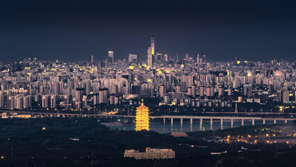 Obraz premium Illuminated Pagoda and Bridge with Modern Skyscrapers at Twilight Panoramic Cityscape