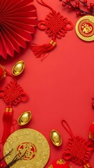 Vertical top view of Chinese New Year decorations including a red fan, gold ingots, red knots, and decorative coins on a red background.