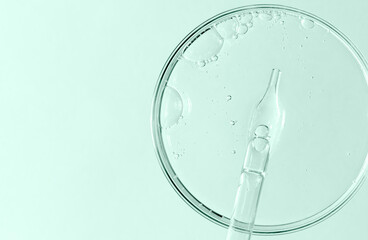 Liquid cosmetic product for the skin in a Petri dish. Copy space