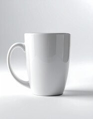 Obraz premium White ceramic coffee mug on pure white background, soft studio lighting