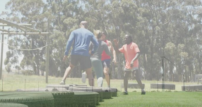 Exercising outdoors, group jumping over tires on grassy field with animation