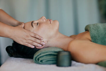 Woman getting head massage at luxury spa