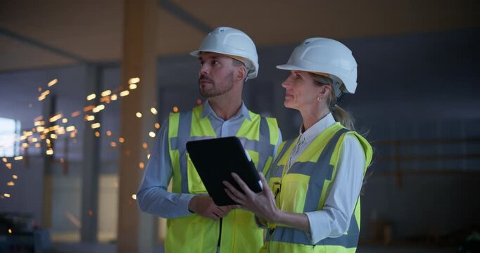 Two Engineers Inspect an Under Construction Commercial Residential Interior, Using a Digital Tablet to Review Work, Check Quality Construction, Plan Real Estate Development, Business Property  - Powered by Adobe