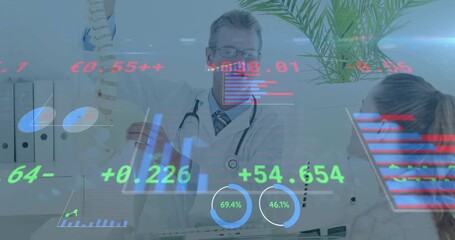 Male doctor entering clinic and lifting spinal model explaining spine anatomy with animated graphs - Powered by Adobe