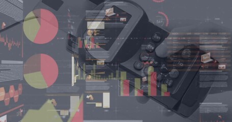 Animation of graphs and financial data over hand of caucasian man holding payment terminal - Powered by Adobe