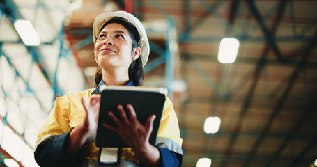 Woman, tablet and warehouse inspection with smile, checklist or notes for inventory management. Person, tech and low angle with application, stock and thinking for supply chain at distribution plant