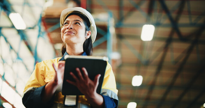 Woman, tablet and warehouse inspection with smile, checklist or notes for inventory management. Person, tech and low angle with application, stock and thinking for supply chain at distribution plant