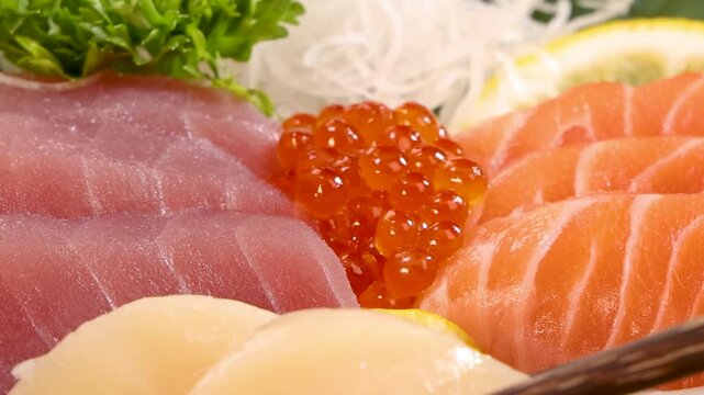 Chopsticks Lifting Fresh Scallop Sashimi From Assorted Seafood Platter