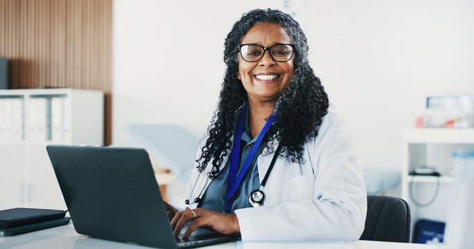 Smile, black woman and portrait of doctor with laptop for medical, healthcare or admin in office. Cardiologist, mature person and tech with clinic schedule, telehealth or research for service