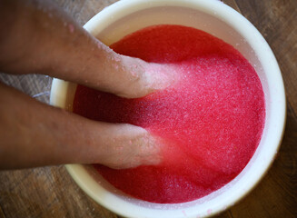 Relaxing foot spa treatment with pink gel.