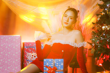 Portrait of woman in Santa dress looking confidently at camera