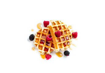 Delicious waffles with berries on white background.