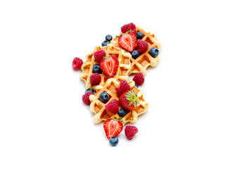 Delicious waffles with berries on white background.