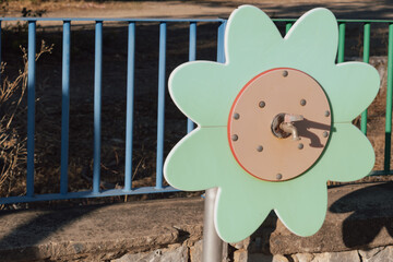 Colorful floral water faucet on a playground, providing a source of water for kids