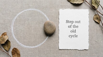 Stone in chalk circle with motivational words on paper