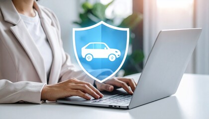 Businessperson types on laptop with car insurance shield icon.