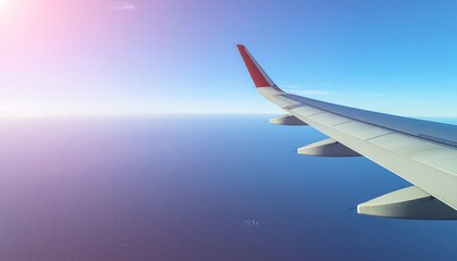 Airplane wing flying high above ocean.