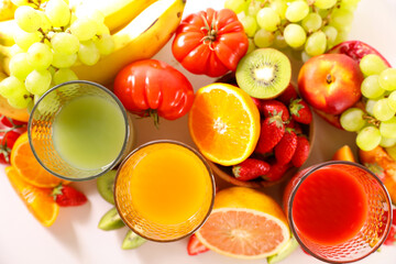 glasses of fresh fruits juices with fresh fruits