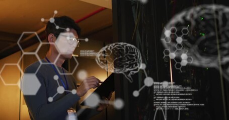 Animation of medical data processing over asian male engineer writing on clipboard at server room - Powered by Adobe