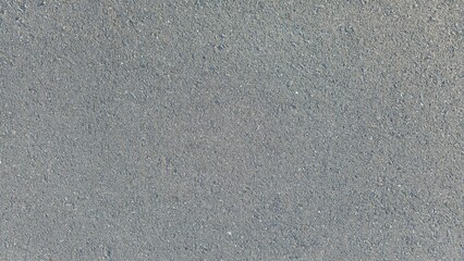 Dark gray asphalt road. Gray gravel concrete floor, road surface, walkway surface, small gravel road surface, texture, and background. © Kawee